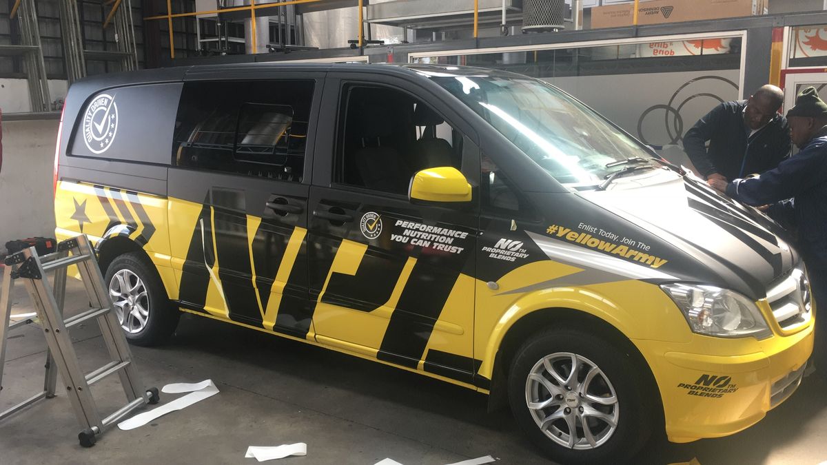 A vehicle being wrapped in the Capital Branding workshop